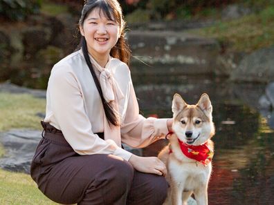 Japan's Princess Aiko, daughter of Emperor Naruhito and Empress Masako, poses for a photograph with her pet dog Yuri at her residence in Tokyo on Nov. 22, 2020. Princess Aiko celebrates her 19th birthday on Tuesday, Dec. 1, 2020