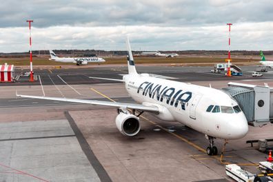 HELSINKI, FINLAND - OCTOBER 24, 2019: Airplanes in the apron and on taxi ways at Helsinki Vantaa international airport on a cloudy autumn day.