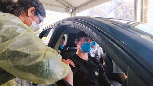 A P-plater gets his coronavirus vaccine at the drive-in hub at Werribee.