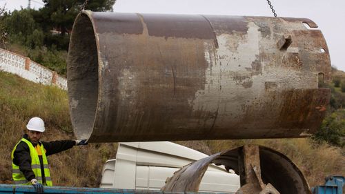 A worker directs a pipe as part of excavation works to rescue the two-year old boy. 