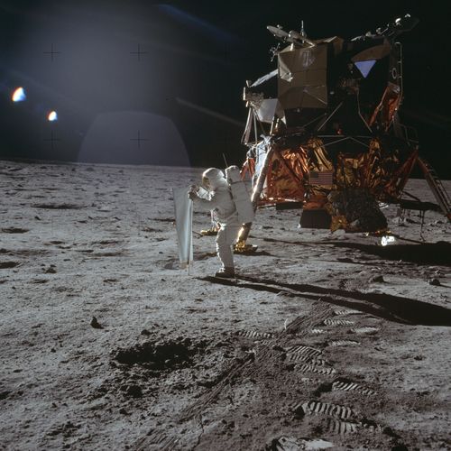 Apollo 11 astronaut Buzz Aldrin deploys a solar wind experiment on the surface of the moon.