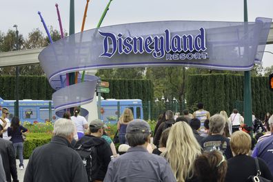 Anaheim, California, USA - April 30, 2013: A large group of people entering the Disneyland Resort in Anaheim, where Disneyland Park and Disney California Adventure Park are located.