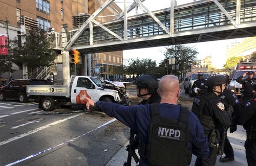 In this photo provided by the New York City Police Department, officers respond to a report of gunfire along West Street. (AP)