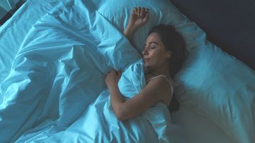 Woman sleeps in her bed.