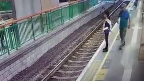 The cleaner is standing on the platform waiting for a train and is unaware what is about to happen. (Facebook)