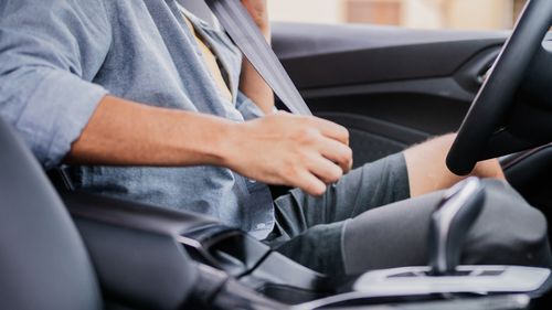 Mid adult man putting the seat in the car