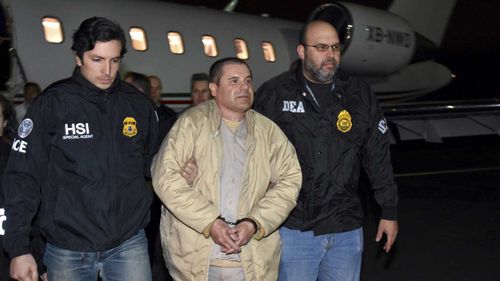 Joaquin Guzman, or El Chapo, is escorted off a plane.