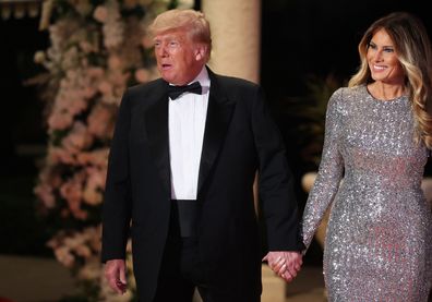 PALM BEACH, FLORIDA - DECEMBER 31: Former U.S. President Donald Trump and former first lady Melania Trump arrive for a New Years event at his Mar-a-Lago home on December 31, 2022 in Palm Beach, Florida. Trump continues to run for a second term as the President of the United States. (Photo by Joe Raedle/Getty Images)