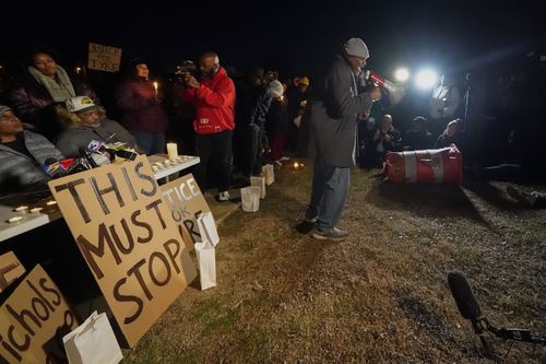 Rev. Andre E Johnson, of the Gifts of Life Ministries, preaches at a candlelight vigil for Tyre Nichols, who died after being beaten by Memphis police officers, in Memphis, Tenn., Thursday, Jan. 26, 2023. Behind him, seated at left, is Tyre's stepfather Rodney Wells 