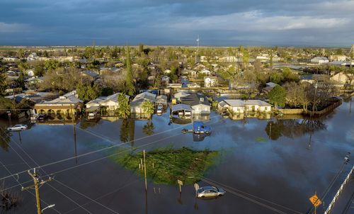 Following days of rain, floodwaters surround homes and vehicles in the Planada community of Merced County, Calif., on Tuesday, Jan. 10, 2023. 