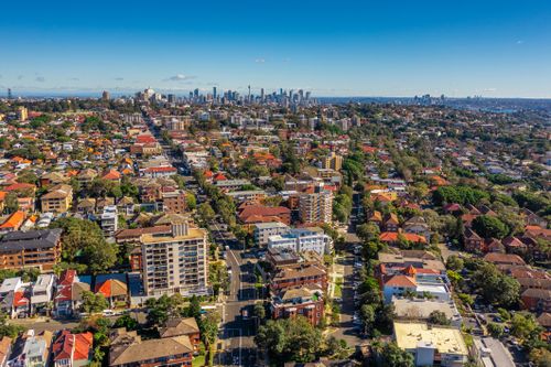 Bondi suburb in South Sydney. Drone aerial photo of Bondi with Sydney CBD and Harbour Bridge in the distance
