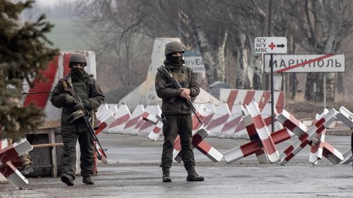 Ukrainian soldiers stand on a check-point close to the line of separation from pro-Russian rebels, Mariupol, Donetsk region, Ukraine