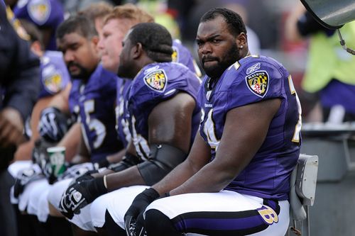 Baltimore Ravens offensive tackle Michael Oher sits on the bench 