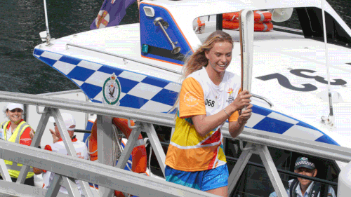 Macy Callaghan in Queen's Baton relay in Sydney’s Darling Harbour. (AAP)