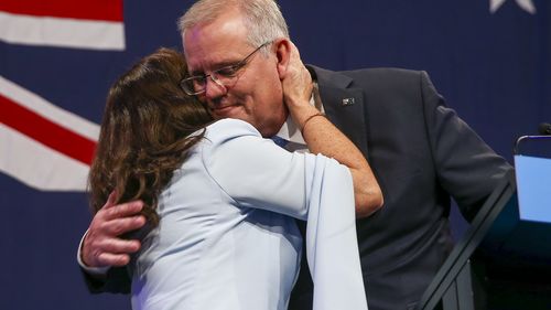 Australian Prime Minister Scott Morrison is embraced by his wife Jenny during his address to a Liberal Party function in Sydney, Australia, Saturday, May 21, 2022.  
