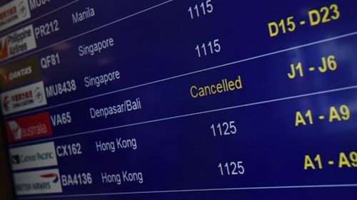 A cancelled flight (unrelated to the Fly365 collapse) is seen on the flight board at Sydney International Airport.