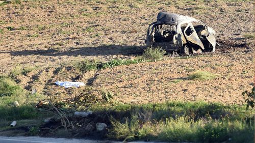 The wreckage of the car of investigative journalist Daphne Caruana Galizia after a car bomb which killed her, next to a road in the town of Mosta, Malta (AP Photo/Rene Rossignaud, file)