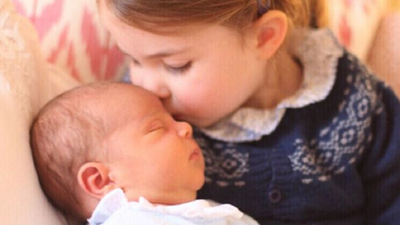 Princess Charlotte kisses baby brother Prince Louis at Kensington Palace, May, 2018