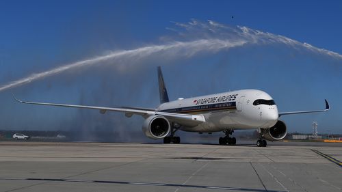 Flight SQ237 from Singapore receives a water canon salute on the tarmac at Tullamarine Airport on November 1, 2021 in Melbourne, as quarantine-free travel begin for Aussies.
