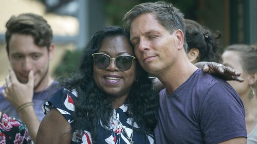 Don Damond, the fiance of Justine Damond, is comforted outside his home by Valerie Castile, the mother of Philando Castile