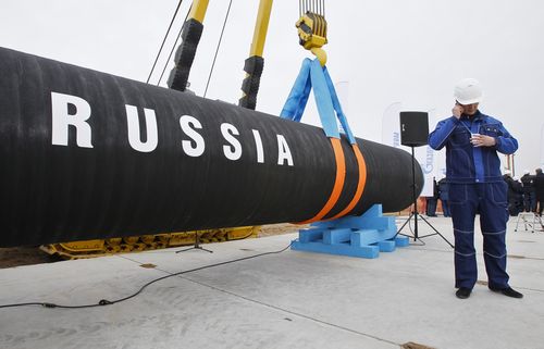 FILE - A Russian construction worker speaks on a mobile phone during a ceremony marking the start of Nord Stream pipeline construction in Portovaya Bay some 170 km north-west from St. Petersburg, Russia on April 9, 2010. Russian energy giant Gazprom said Friday, Sept. 2, 2022 that it can't resume the supply of natural gas through a key pipeline to Germany for now because of what it said was a need for urgent maintenance work, just hours before it was due to recommence deliveries. 