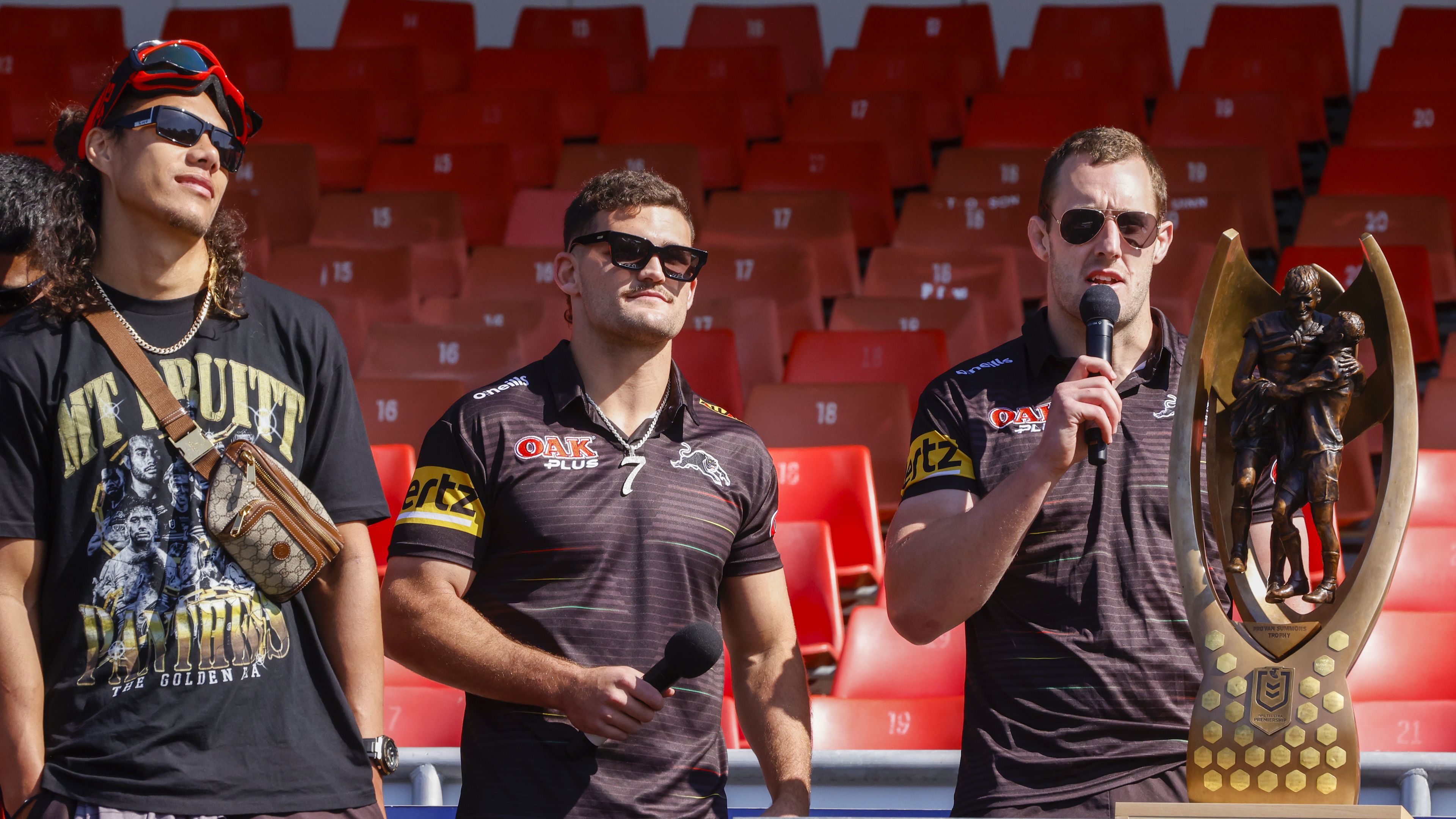 Isaah Yeo speaks as Nathan Cleary (C) and Jarome Luai (L) look on during a fan day at BlueBet Stadium.