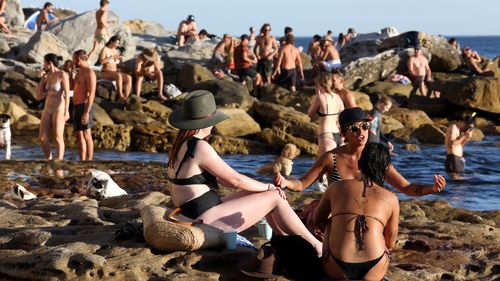 Beachgoers are seen at Bondi Beach despite the threat of Coronavirus (COVID-19) in Sydney, Friday, March 20, 2020.