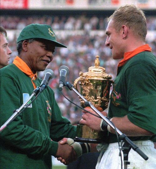 Mandela presents the Webb Ellis trophy to Springboks captain Francois Pienaar. 