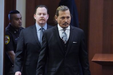 Actor Johnny Depp walks into the courtroom after a break at the Fairfax County Circuit Courthouse in Fairfax, Va., Monday April 18, 2022. Depp sued his ex-wife Amber Heard for libel in Fairfax County Circuit Court after she wrote an op-ed piece in The Washington Post in 2018 referring to herself as a "public figure representing domestic abuse." (AP Photo/Steve Helber, Pool)