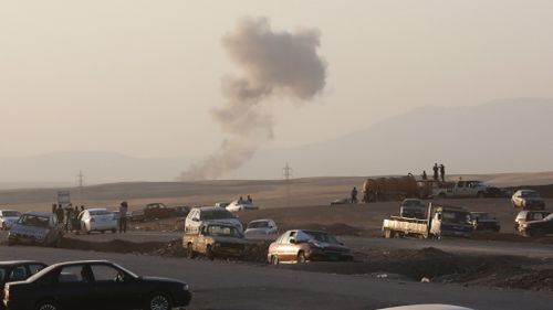 Smoke rises after airstrikes targeting Islamic State militants near the Khazer checkpoint outside of the city of Irbil in northern Iraq, Friday, Aug. 8, 2014. (AP Photo/ Khalid Mohammed)