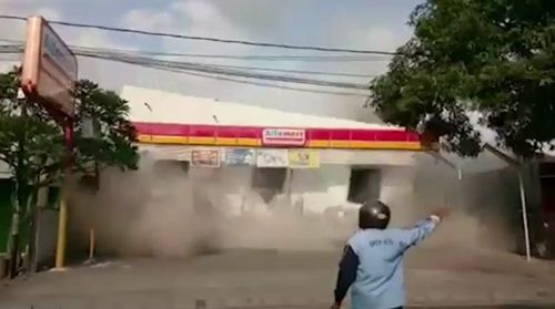 This man was filmed standing within metres of a building as it was pancaked by the aftershock. Picture: Supplied.