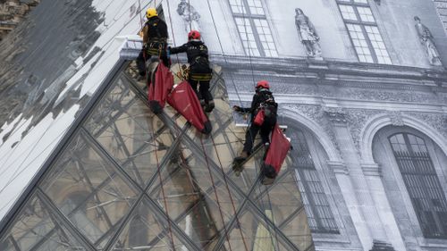 The Louvre Pyramid became the subject of a major installation. (AFP)