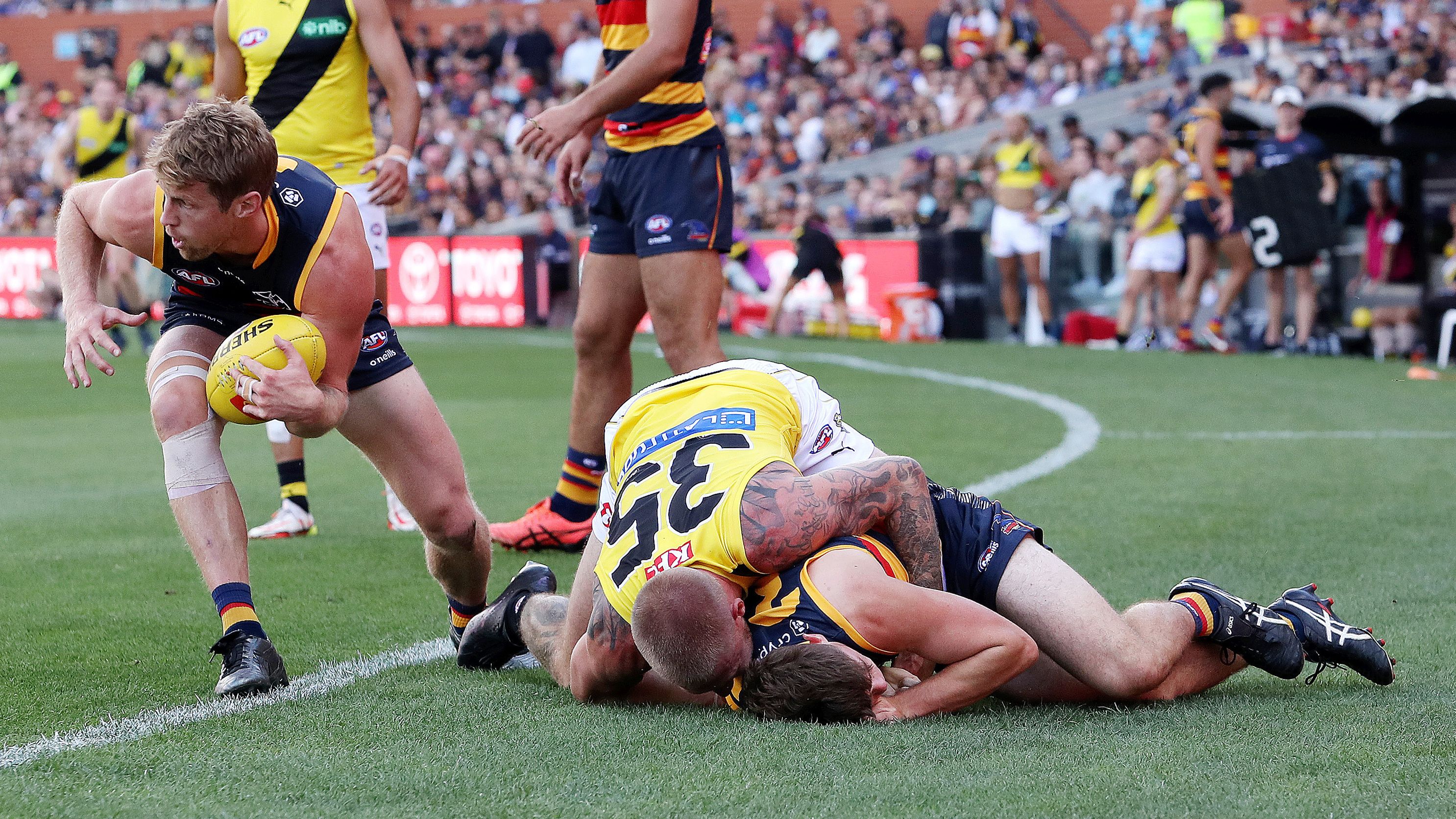 ADELAIDE, AUSTRALIA - MARCH 25: Patrick Parnell of the Crows is tackled by Nathan Broad of the Tigers during the 2023 AFL Round 02 match between the Adelaide Crows and the Richmond Tigers at Adelaide Oval on March 25, 2023 in Adelaide, Australia. (Photo by Sarah Reed/AFL Photos)