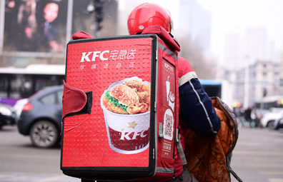 A delivery staff of the KFC rides an electric bicycle along a road on January 8, 2020 in Shenyang, Liaoning Province of China. 