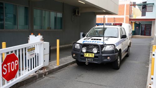 A New South Wales police vehicle leaves the Southport Watch House on the Gold Coast. (AAP)