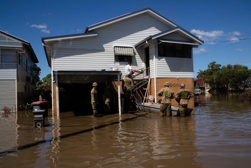Members of the ADF join up with community volunteers to clear the house of elderly couple, Gail and Bill Ferrier, in Woodburn, in the Northern Rivers region of NSW. 