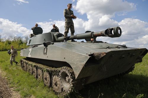 A crew of self-propelled artillery vehicles 'Gvozdika' ('Carnation') of Donetsk People's Republic militia prepare to fire towards Ukrainian army position, near the town of Yasynuvataya, outside Donetsk, in territory under the government of the Donetsk People's Republic, eastern Ukraine, Friday, May 20, 2022. (AP Photo/Alexei Alexandrov)