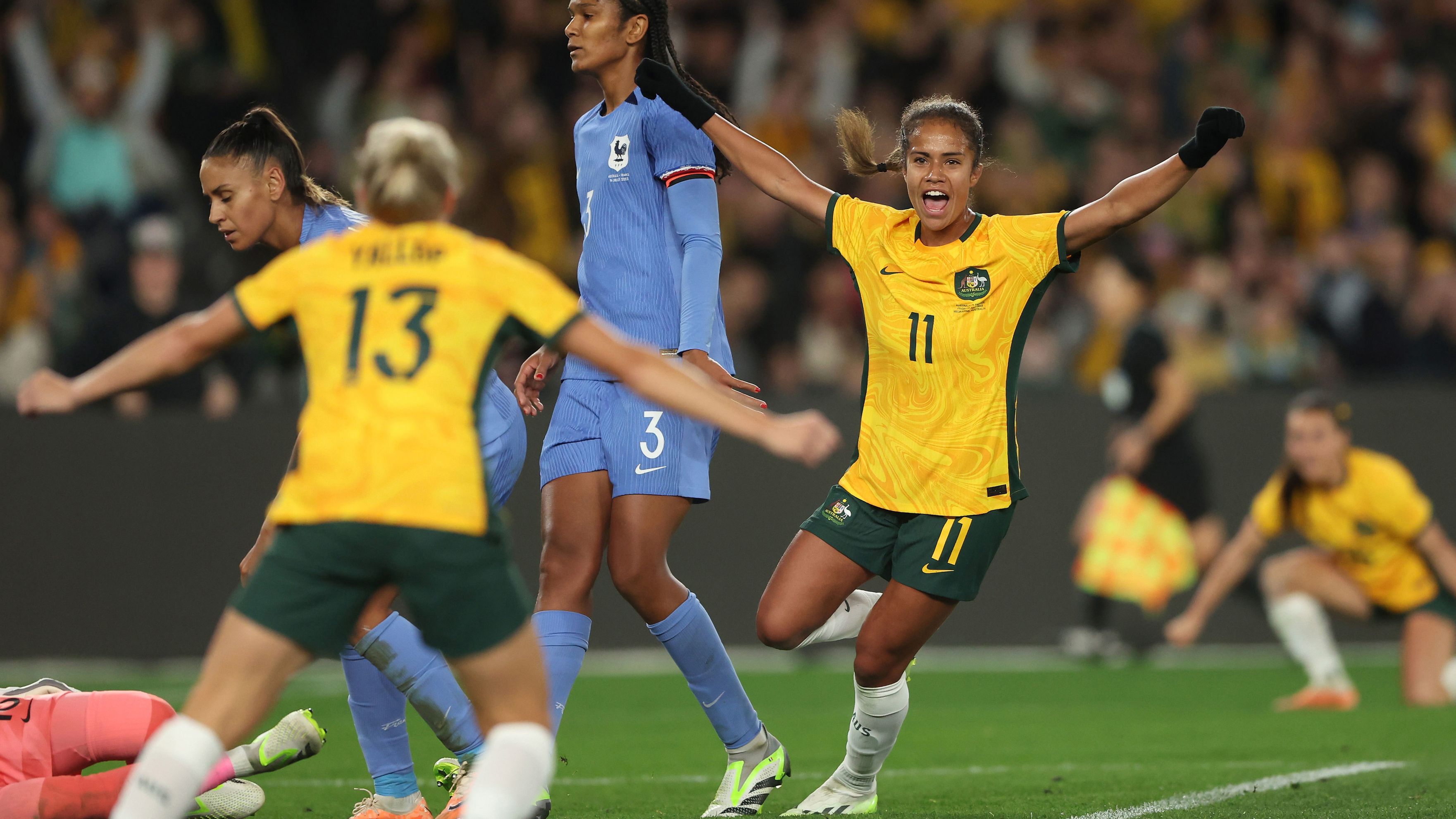 Matildas star Mary Fowler celebrates scoring a goal against France in the World Cup warm-up match in Melbourne.