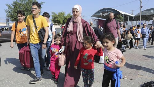 Palestinians cross to the Egyptian side of the Rafah border