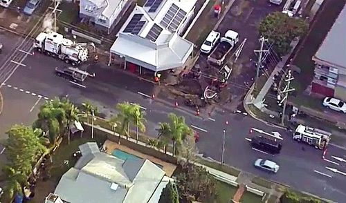 Residents of a suburban Brisbane street have told of how they awoke to their homes and backyards being flooded after a burst water main caused a sinkhole this morning