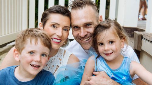 Louise (top left) with her husband (Dominic) and their two young children.