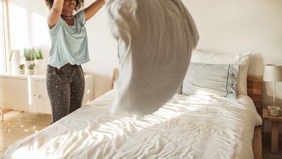 A woman making her bed