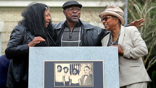 Relatives of the Groveland Four, from left, Vivian Shepherd, niece of Sam Shepherd, Gerald Threat, nephew of Walter Irvin; Carol Greenlee, daughter of Charles Greenlee, gather at the just-unveiled monument in front of the Old Lake County courthouse in Tavares, Florida.