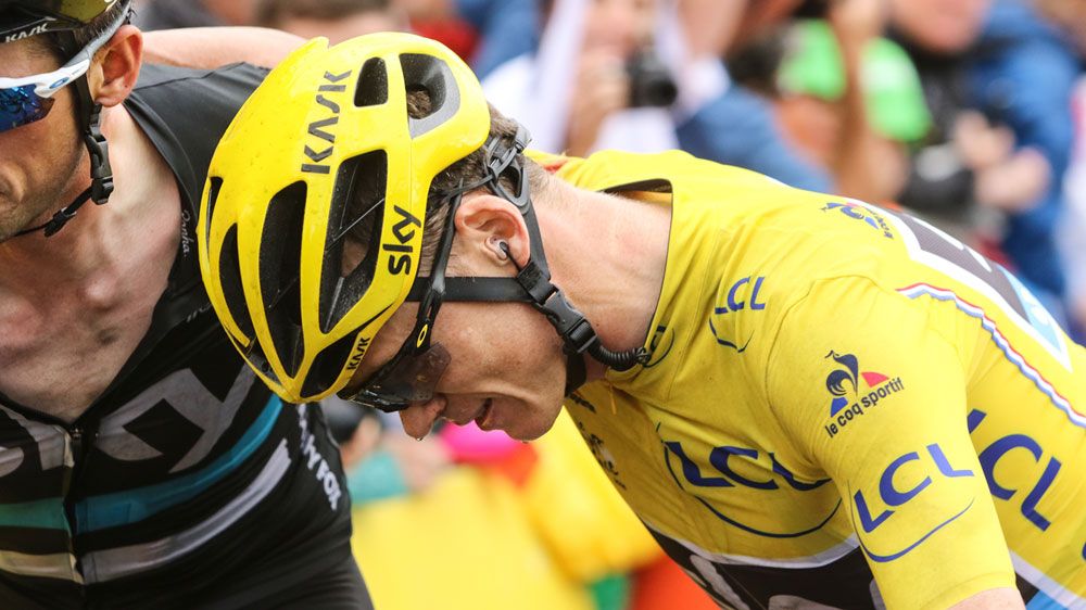 Froome defies crash to maintain lead