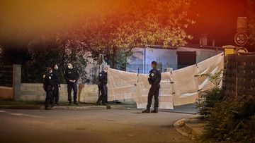 Police guard the scene where police shot a man after he decapitated a middle school teacher and posted the act on social media on October 16, 2020 in Conflans-Sainte-Honorine, France