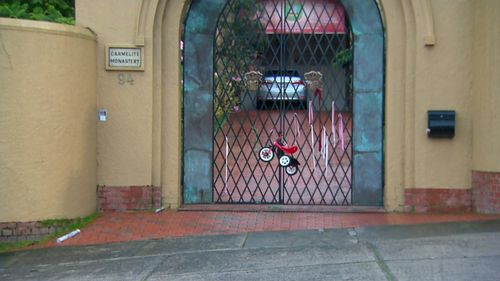 A child's tricycle was left tied to the gate of the residence Cardinal George Pell spent the night at. A day earler the High Court overturned all convictions againbst Pell.