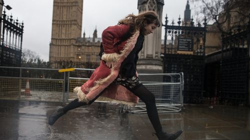Wind, rain and snow outside the Houses of Parliament in central London. (AFP)