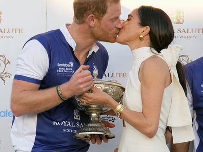 Prince Harry and Meghan Markle, Duchess of Sussex, kiss as she presents his polo team with the trophy for winning the Royal Salute Polo Challenge to Benefit Sentebale, Friday, April 12, 2024, in Wellington, Florida