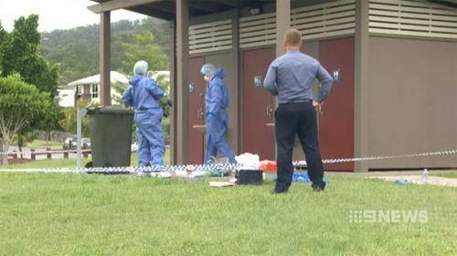 Forensics police examine a toilet block located near the crime scene. (9NEWS)