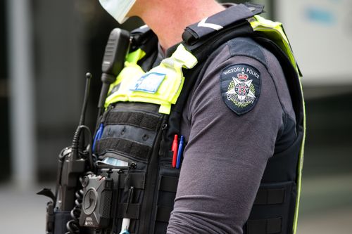 Members of Victoria Police attend a protest in Melbourne. Generic police officers uniform badge logo. Photo by Paul Rovere